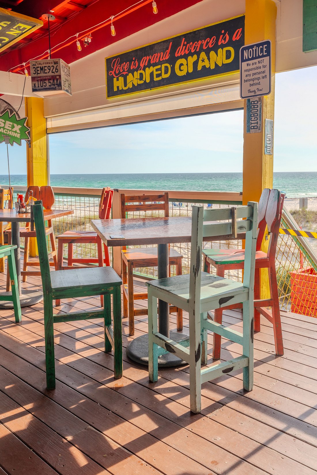 Beachfront deck with colorful tables and chairs at Señor Frog's