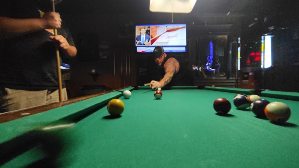 Pool table in a dimly lit bar at Whiskey's Saloon