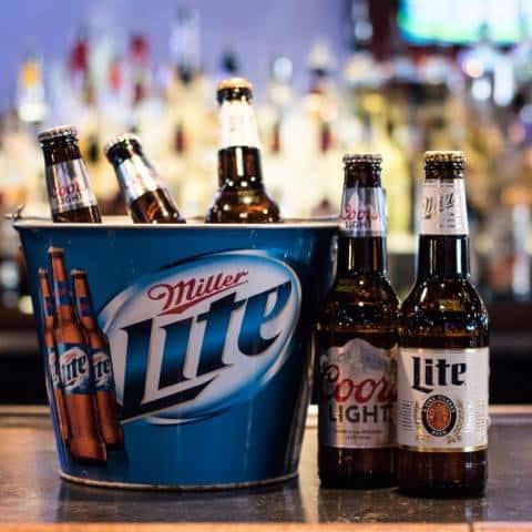 Ice bucket of beer bottles on a bar