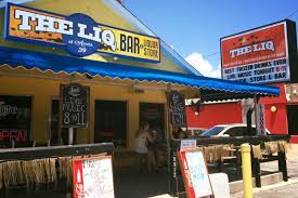 The Liq bar and liquor store storefront on Front Beach Road