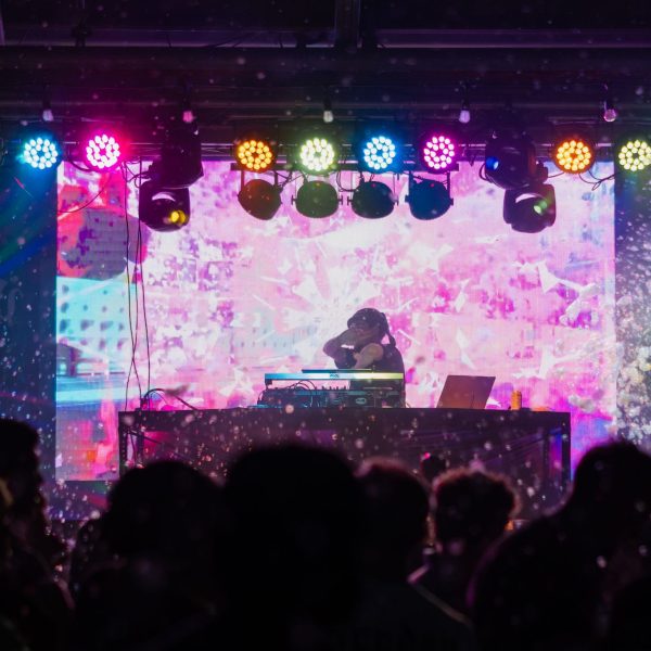 Wide stage with colored lights and DJ, PCB Spring Break 2026