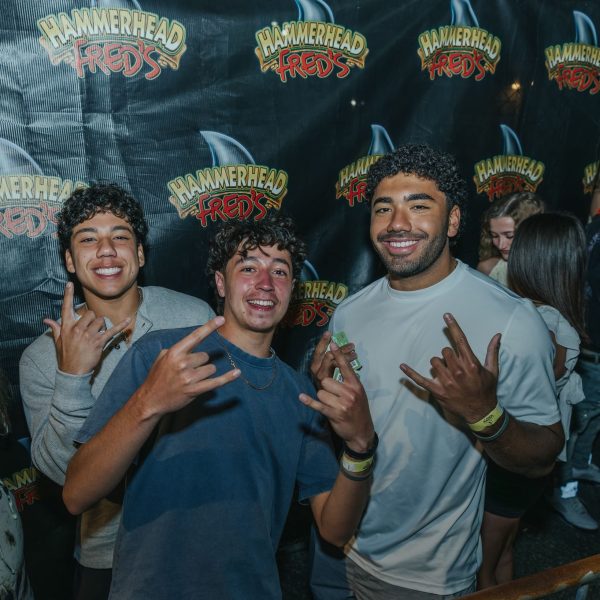 Guys at Hammerhead Fred's backdrop, PCB Spring Break 2026
