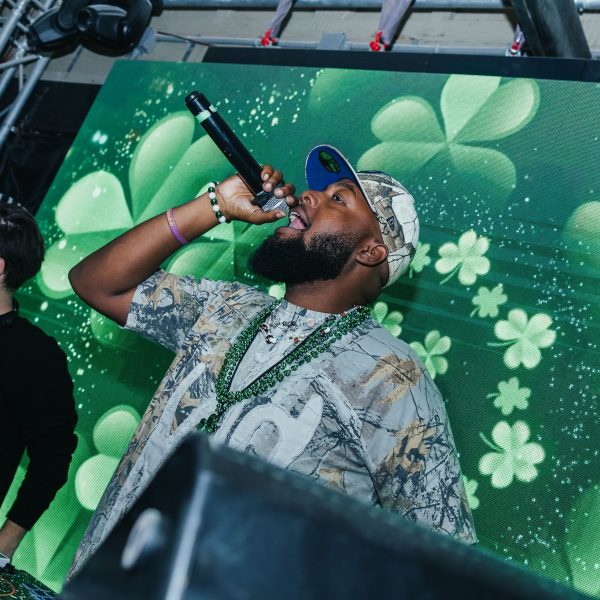 DJ with shamrock screen, PCB Spring Break 2026