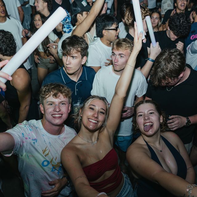 Friends cheering with glow sticks at PCB Spring Break 2026