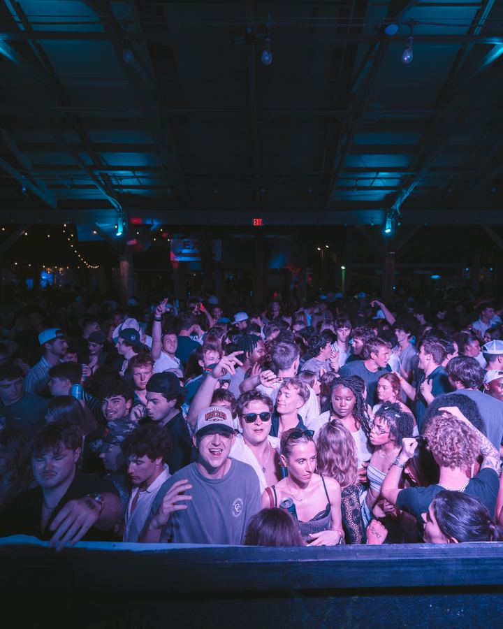 Wide view of a packed crowd under the roof