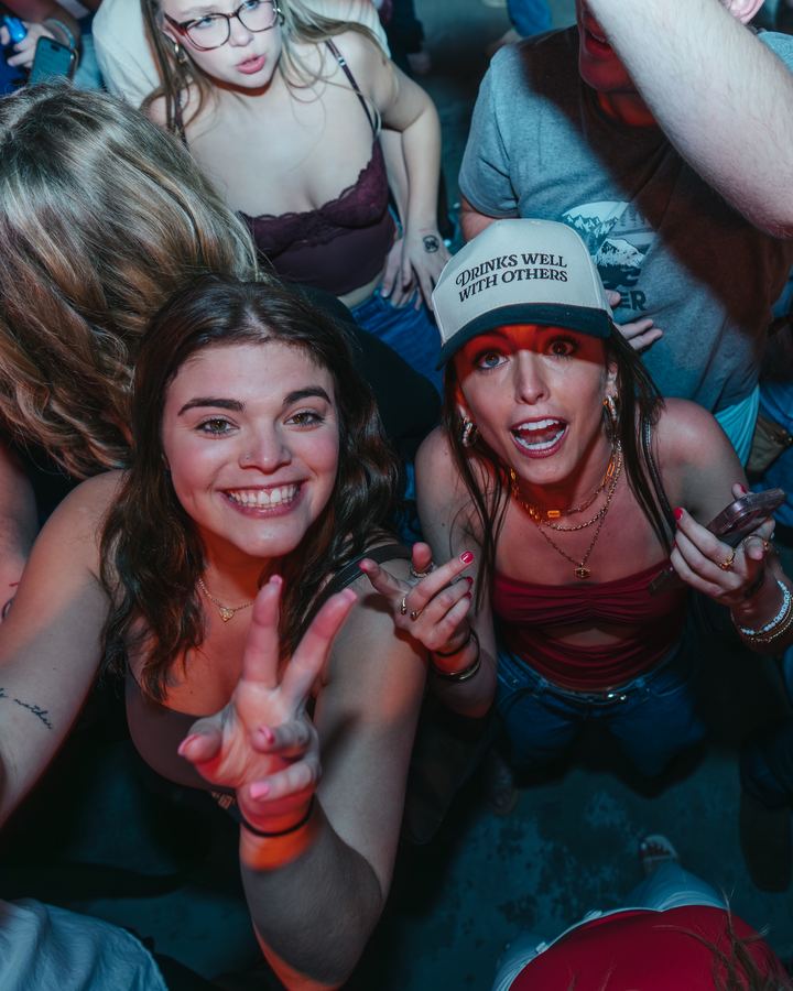 Two friends with peace signs